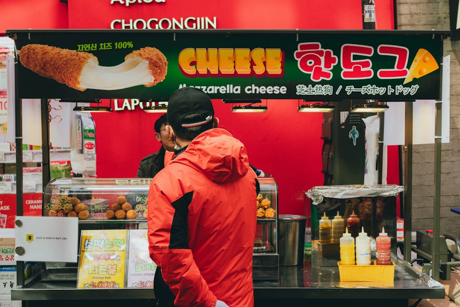 A vibrant street food stall in Seoul featuring mozzarella cheese hot dogs. Perfect for travel enthusiasts.