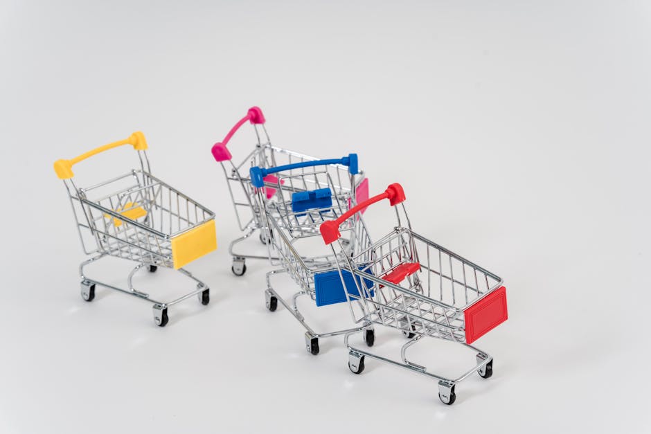 Three mini shopping carts with colorful handles and labels on a white background.